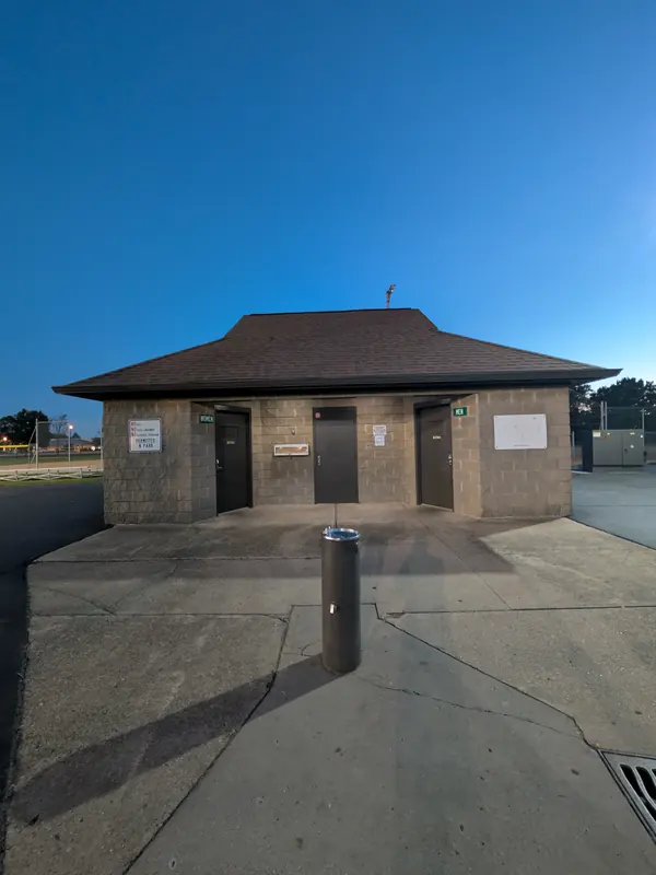 Restroom building with separate women's and men's doors and a drinking fountain